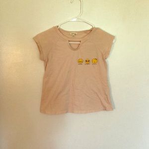 A white pink T-shirt with emoji’s on it